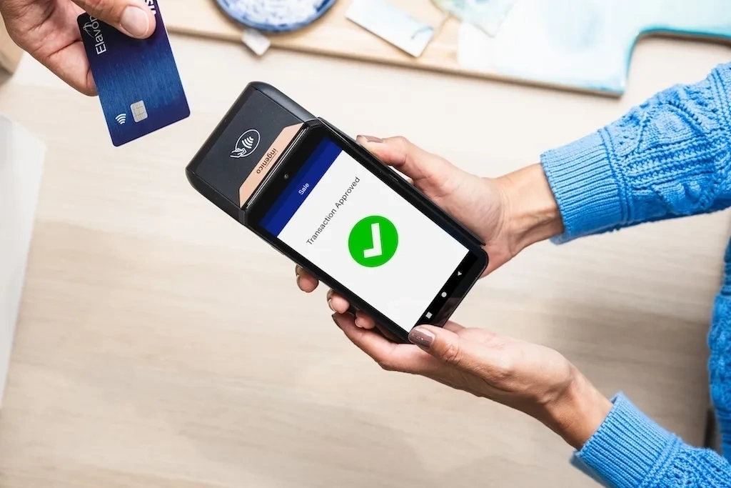 Front view of the Elavon DX8000 payment terminal, featuring a touchscreen display and keypad, designed for secure in-store card transactions.