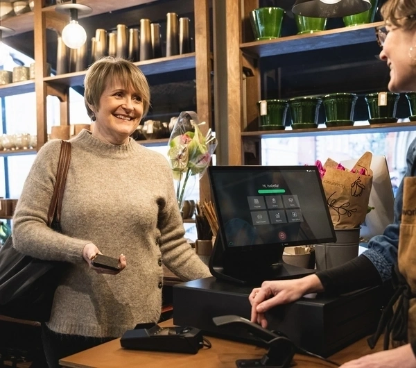 Lady making a payment at cash register
