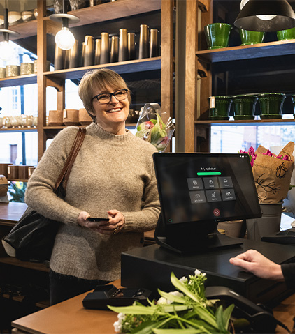 A lady paying by card at the counter